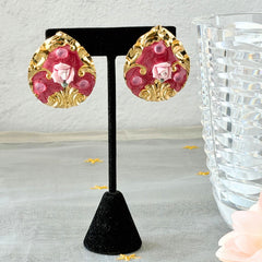 Vintage 1980s teardrop post earrings with 3D pink polymer clay rose, pink enamel base, and gold tone pressed metal scrollwork on original card.