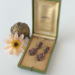 Vintage Hollycraft pink and yellow rhinestone gold‑tone floral dangle screw‑back earrings shown from different angles.