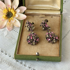Vintage Hollycraft pink and yellow rhinestone gold‑tone floral dangle screw‑back earrings shown from different angles.