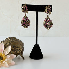 Vintage Hollycraft pink and yellow rhinestone gold‑tone floral dangle screw‑back earrings shown from different angles.