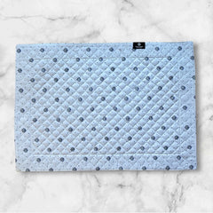 Reversible quilted cotton placemat in Lauris Light Yellow by Marat d’Avignon, featuring a white center with lavender purple floral medallions and a border of lavender sprigs and olive branches, with a white reverse side  scattered with tiny lavender  blossoms, crafted in Provence.