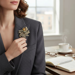 Vintage H. Pomerantz floral brooch featuring a large topaz-colored marquise rhinestone set in gold-tone metal, accented with green and cream enamel leaves and clear rhinestones; signed on the reverse, circa 1940s, measuring 3 inches by 3 inches.