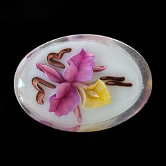 Vintage French reverse carved Lucite brooch featuring a hand-painted pink and yellow orchid on a white background. Oval shape with dimensional floral detail, excellent condition, circa 1950s.