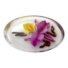 Vintage French reverse carved Lucite brooch featuring a hand-painted pink and yellow orchid on a white background. Oval shape with dimensional floral detail, excellent condition, circa 1950s.