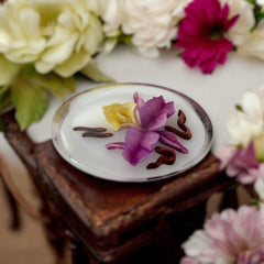 Vintage French reverse carved Lucite brooch featuring a hand-painted pink and yellow orchid on a white background. Oval shape with dimensional floral detail, excellent condition, circa 1950s.