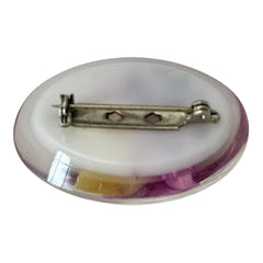 Vintage French reverse carved Lucite brooch featuring a hand-painted pink and yellow orchid on a white background. Oval shape with dimensional floral detail, excellent condition, circa 1950s.