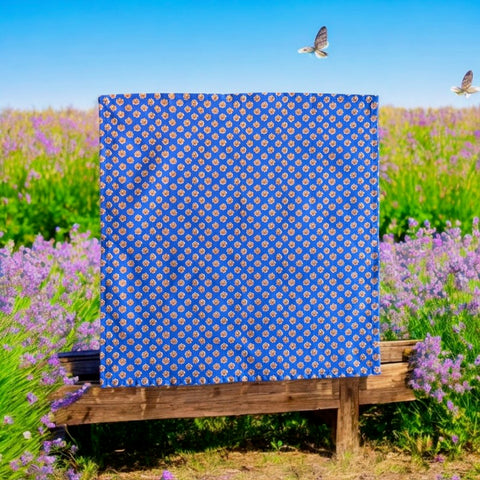 Provence cotton napkins featuring a blue background with light brown floral designs from the Le Cluny Olives Mimosa French Country Collection, made of 100% cotton, measuring 18" x 18", with vibrant, fade-resistant prints.
