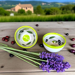 Small round ceramic bowl with green interior and rim, hand-painted with swirling olive branches, black olives, and green leaves on a beige base; measures 4 inches in diameter and 2.5 inches high.
