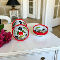 Mini ceramic bowl with red rim and white base, hand-painted with black olives and green leaves; measures 3¾ inches in diameter and 1¾ inches high, ideal for condiments or small servings.
