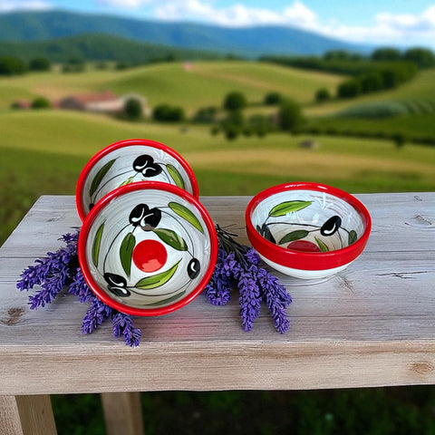 Mini ceramic bowl with red rim and white base, hand-painted with black olives and green leaves; measures 3¾ inches in diameter and 1¾ inches high, ideal for condiments or small servings.