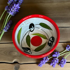 Mini ceramic bowl with red rim and white base, hand-painted with black olives and green leaves; measures 3¾ inches in diameter and 1¾ inches high, ideal for condiments or small servings.