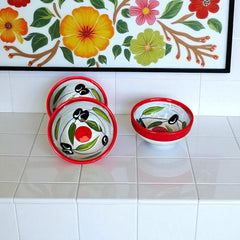 Mini ceramic bowl with red rim and white base, hand-painted with black olives and green leaves; measures 3¾ inches in diameter and 1¾ inches high, ideal for condiments or small servings.