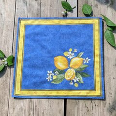 Provence cotton napkins in blue with yellow lemon motif, green leaves, and delicate lemon blossoms.