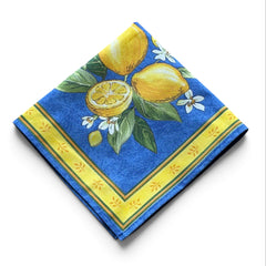 Provence cotton napkins in blue with yellow lemon motif, green leaves, and delicate lemon blossoms.