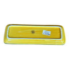 Rectangular ceramic spoon rest with yellow interior and green polka-dot rim, featuring hand-painted olive leaves, red berries, and whimsical fork and spoon motif; measures 11 by 4 inches.