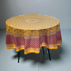 Round coated cotton tablecloth in golden yellow and deep red, featuring concentric Provençal floral and geometric patterns