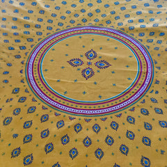 Round coated cotton tablecloth in golden yellow and deep red, featuring concentric Provençal floral and geometric patterns