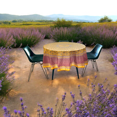 Round coated cotton tablecloth in golden yellow and deep red, featuring concentric Provençal floral and geometric patterns