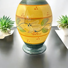 Handmade ceramic oil bottle or vase from Provence, featuring a yellow glaze with green accents and hand-painted white floral motif, signed Bleu d’Argile France