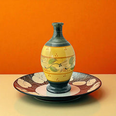 Handmade ceramic oil bottle or vase from Provence, featuring a yellow glaze with green accents and hand-painted white floral motif, signed Bleu d’Argile France
