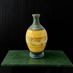 Handmade ceramic oil bottle or vase from Provence, featuring a yellow glaze with green accents and hand-painted white floral motif, signed Bleu d’Argile France