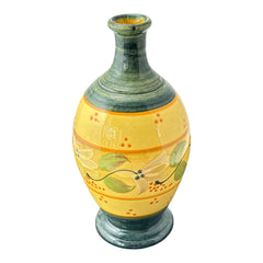Handmade ceramic oil bottle or vase from Provence, featuring a yellow glaze with green accents and hand-painted white floral motif, signed Bleu d’Argile France