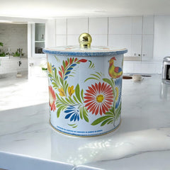 Round cookie tin box in Quimper designs, available in Floral or Rooster patterns. Cylindrical tin with a moisture-absorbing lid for keeping cookies fresh. Perfect for adding a French country charm to your kitchen.