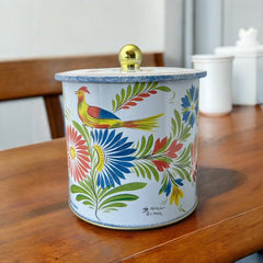 Round cookie tin box in Quimper designs, available in Floral or Rooster patterns. Cylindrical tin with a moisture-absorbing lid for keeping cookies fresh. Perfect for adding a French country charm to your kitchen.