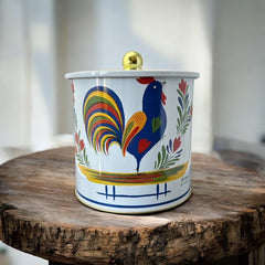 Round cookie tin box in Quimper designs, available in Floral or Rooster patterns. Cylindrical tin with a moisture-absorbing lid for keeping cookies fresh. Perfect for adding a French country charm to your kitchen.