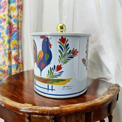 Round cookie tin box in Quimper designs, available in Floral or Rooster patterns. Cylindrical tin with a moisture-absorbing lid for keeping cookies fresh. Perfect for adding a French country charm to your kitchen.
