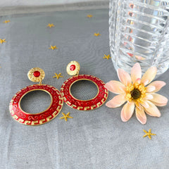 Vintage 1980s red enamel and gold‑tone circle dangle post earrings with pressed scroll and Greek key design on original Impressions card.