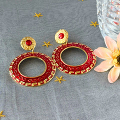 Vintage 1980s red enamel and gold‑tone circle dangle post earrings with pressed scroll and Greek key design on original Impressions card.