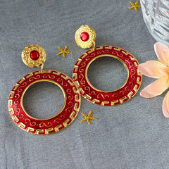 Vintage 1980s red enamel and gold‑tone circle dangle post earrings with pressed scroll and Greek key design on original Impressions card.