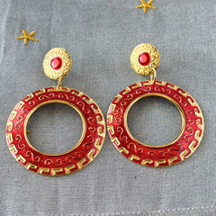 Vintage 1980s red enamel and gold‑tone circle dangle post earrings with pressed scroll and Greek key design on original Impressions card.