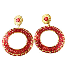 Vintage 1980s red enamel and gold‑tone circle dangle post earrings with pressed scroll and Greek key design on original Impressions card.