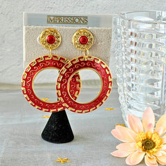Vintage 1980s red enamel and gold‑tone circle dangle post earrings with pressed scroll and Greek key design on original Impressions card.