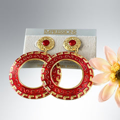 Vintage 1980s red enamel and gold‑tone circle dangle post earrings with pressed scroll and Greek key design on original Impressions card.