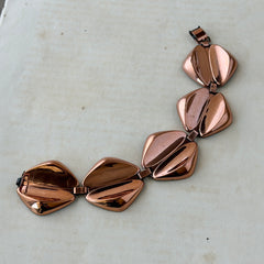 Vintage Renoir Modernist copper bracelet with geometric diamond‑shaped links and fold‑over clasp, signed Renoir.