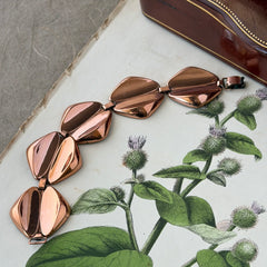 Vintage Renoir Modernist copper bracelet with geometric diamond‑shaped links and fold‑over clasp, signed Renoir.