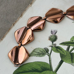 Vintage Renoir Modernist copper bracelet with geometric diamond‑shaped links and fold‑over clasp, signed Renoir.