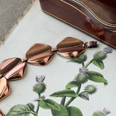 Vintage Renoir Modernist copper bracelet with geometric diamond‑shaped links and fold‑over clasp, signed Renoir.