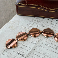 Vintage Renoir Modernist copper bracelet with geometric diamond‑shaped links and fold‑over clasp, signed Renoir.