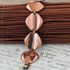 Vintage Renoir Modernist copper bracelet with geometric diamond‑shaped links and fold‑over clasp, signed Renoir.