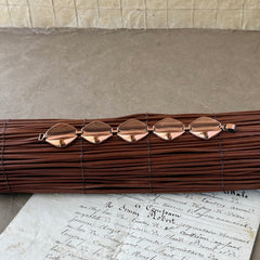 Vintage Renoir Modernist copper bracelet with geometric diamond‑shaped links and fold‑over clasp, signed Renoir.