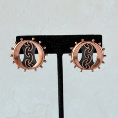 Vintage Renoir copper and black modernist clip‑on earrings with circular bead rim and sculptural center design, signed Renoir.