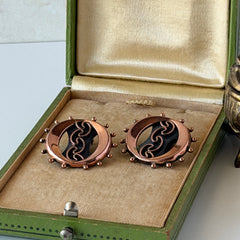 Vintage Renoir copper and black modernist clip‑on earrings with circular bead rim and sculptural center design, signed Renoir.