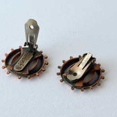 Vintage Renoir copper and black modernist clip‑on earrings with circular bead rim and sculptural center design, signed Renoir.
