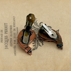 Vintage Matisse Renoir copper clip‑on earrings with orange sugar‑textured art‑glass cabochons.
