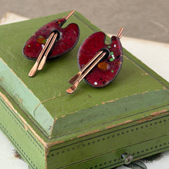 Vintage Matisse Renoir red enamel and copper artist palette earrings with miniature paintbrush design, mid‑century modern clip‑ons from the 1950s–1960s.