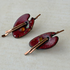 Vintage Matisse Renoir red enamel and copper artist palette earrings with miniature paintbrush design, mid‑century modern clip‑ons from the 1950s–1960s.